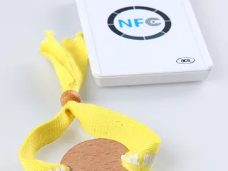 RFID event wristband being tapped on a handheld reader