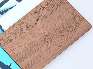 Black walnut wooden RFID card on top of white PVC cards
